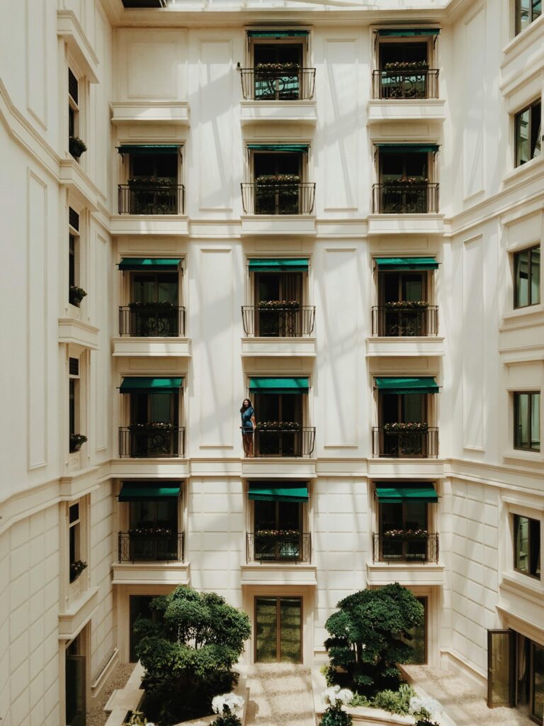 The Evolution of Hotel Booking: Why Vintage Boutique Hotels are Leading the Way - Photo of a white hotel facade with windows